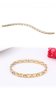Detail view of gold magnetic therapy bracelet with H-shaped links and magnetic stones