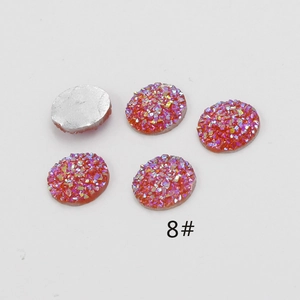 Close-up of orange 12mm resin druzy cabochons with sparkling texture for DIY jewelry
