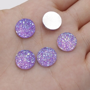 Macro detail of purple 12mm resin crystals with sparkling texture on silver flat back