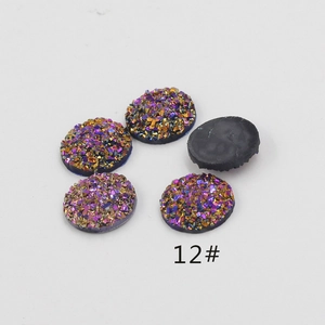 Macro detail of 12mm resin druzy cabochons in purple and gold glitter for DIY jewelry