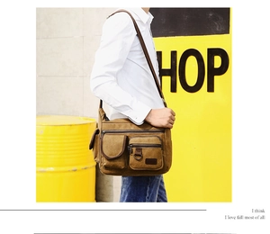 Outdoor shot of men's vintage brown canvas crossbody bag with multiple pockets and strap