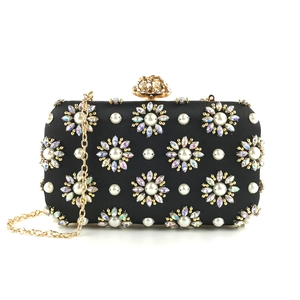 Elegant black evening clutch bag with pearl floral embroidery and golden flower clasp