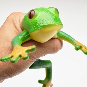 Realistic green tree frog squeeze toy with red eyes and textured skin for stress relief