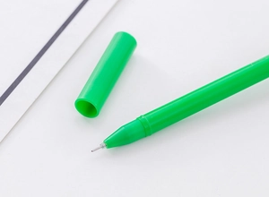Close-up of a green watermelon-themed gel pen with a fine tip on a white surface