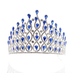 Close-up of luxury silver crown featuring blue teardrop gems and sparkling rhinestones