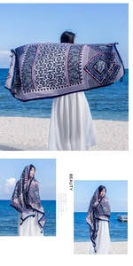Detail view of large bohemian beach scarf with colorful geometric ethnic prints and tassels