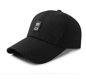 Detail view of black breathable baseball cap with laser-cut holes and luck text patch
