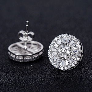 Macro shot of silver plated round halo stud earrings with cubic zirconia pave settings