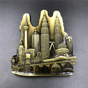 Macro view of 3D metal Malaysia landmarks fridge magnet in embossed bronze finish