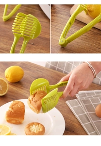 Green handheld food slicer guide for lemons and tomatoes used as a bread serving tong
