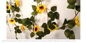 Detail of sunflower garland with yellow silk petals and green leaves for wall decor