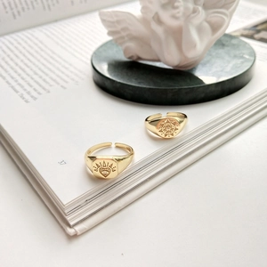 Detail of vintage 925 sterling silver rings with heart and star patterns on a book