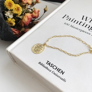 Elegant gold S925 silver bracelet featuring a rose relief coin pendant on a chain