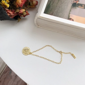 Detailed macro view of S925 sterling silver chain with a vintage rose embossed coin charm