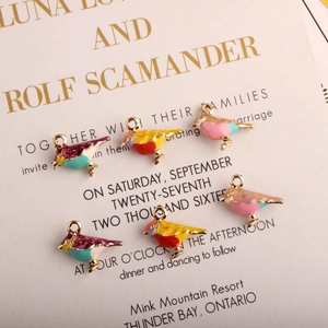 Detailed view of colorful enamel bird charms in gold plating for DIY jewelry making