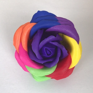 Macro shot of a single rainbow-colored soap rose with vibrant multilayered petals