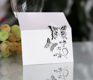 Detailed laser-cut white pearlescent paper card with double butterfly and floral patterns