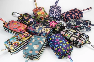 Detail view of multi-layer zipper wallets with various colorful printed patterns