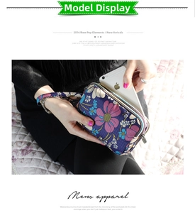 Close-up of three-layered zipper wallet with floral pattern and wrist strap