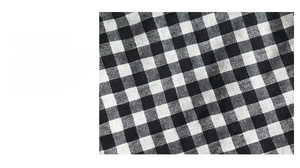 Detailed macro view of soft seersucker fabric with black and white checkered texture