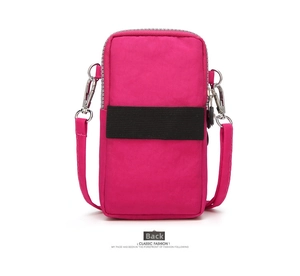 Back view of magenta mini crossbody phone bag with black elastic strap and silver metal hooks