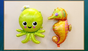 Detailed view of cartoon octopus and seahorse foil balloons for marine themed parties