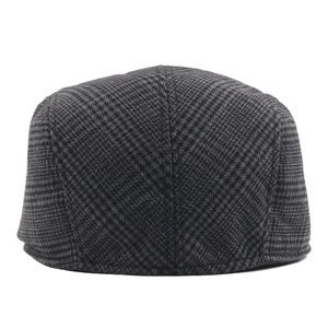 Classic grey and black houndstooth flat cap with vintage British style plaid pattern