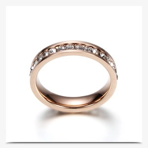 Detail of rose gold stainless steel ring with a single row of sparkling clear crystals