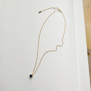 Minimalist 925 silver necklace with a round blue gemstone pendant on a gold chain