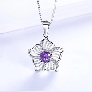 Detailed view of S925 silver floral pendant with purple stone and small diamonds