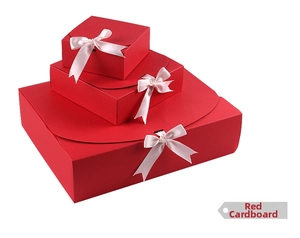 Three-piece red cardstock gift box set with pink ribbon bows in various sizes