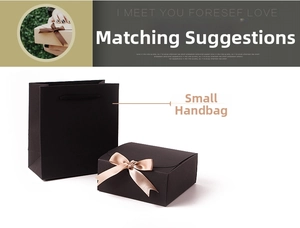 Detail view of small black matte gift box with champagne gold ribbon and matching handbag
