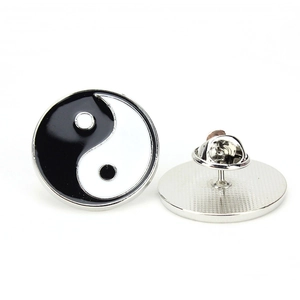 Macro detail of Yin Yang enamel pin showing the polished front and butterfly clutch back