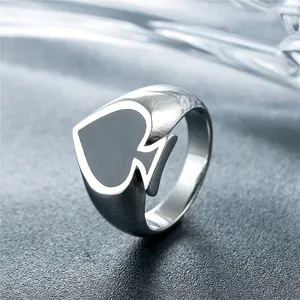 Retro poker spade ring for men made of vintage silver titanium steel on stone background