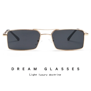 Close-up of retro double-bridge gold metal frame sunglasses with dark lenses