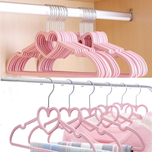 Pink heart-shaped velvet hangers with non-slip texture for organized closet storage