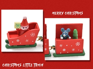 Detailed view of hand-painted wooden Christmas train with Santa and tree figurines