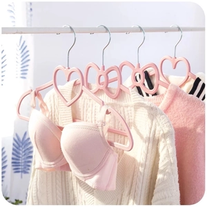 Close-up of pink heart-shaped non-slip plastic hanger with hook for hanging lingerie