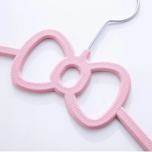 Close-up of pink bow-shaped clothes hanger showing the anti-slip braided texture and hook