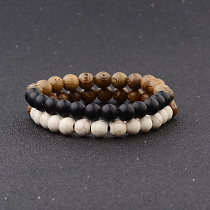 Detailed view of 3-piece beaded bracelet set featuring wood grain, matte black and marble beads