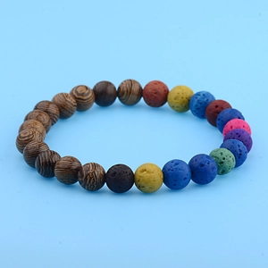 Macro shot of colorful volcanic lava beads and brown wooden beads on an elastic bracelet