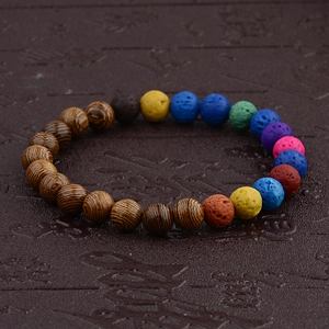 Detail view of wooden beads and colorful lava stone beads on a handmade bracelet