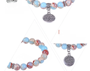 Detailed view of jasper stone beads bracelet with Tree of Life and pattern charms