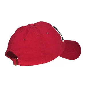 Detail view of red cotton baseball cap featuring adjustable metal buckle and 6-panel design