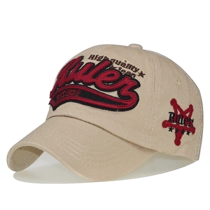 Close-up of 3D embroidery detail on beige cotton baseball cap with Rules 1923 text