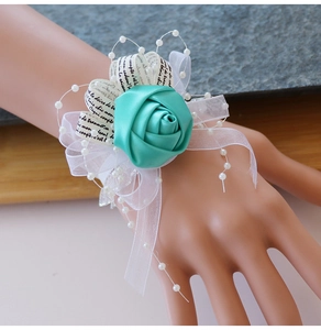 Détail du corsage de poignet en satin bleu Tiffany avec rubans et fausses perles