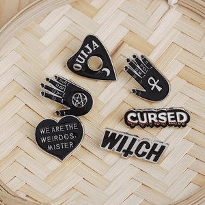 Set of 6 punk gothic enamel pins with Witchcraft and Ouija symbols on a bamboo tray