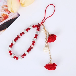 Detail of red beaded phone strap with rhinestone spacers and fabric flower pendant