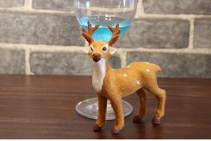 Detailed view of artificial reindeer ornament with realistic brown fur and white spots