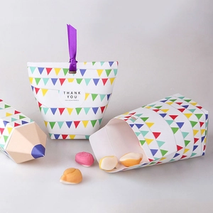 Close-up of colorful gift boxes with flags pattern and purple ribbon handles